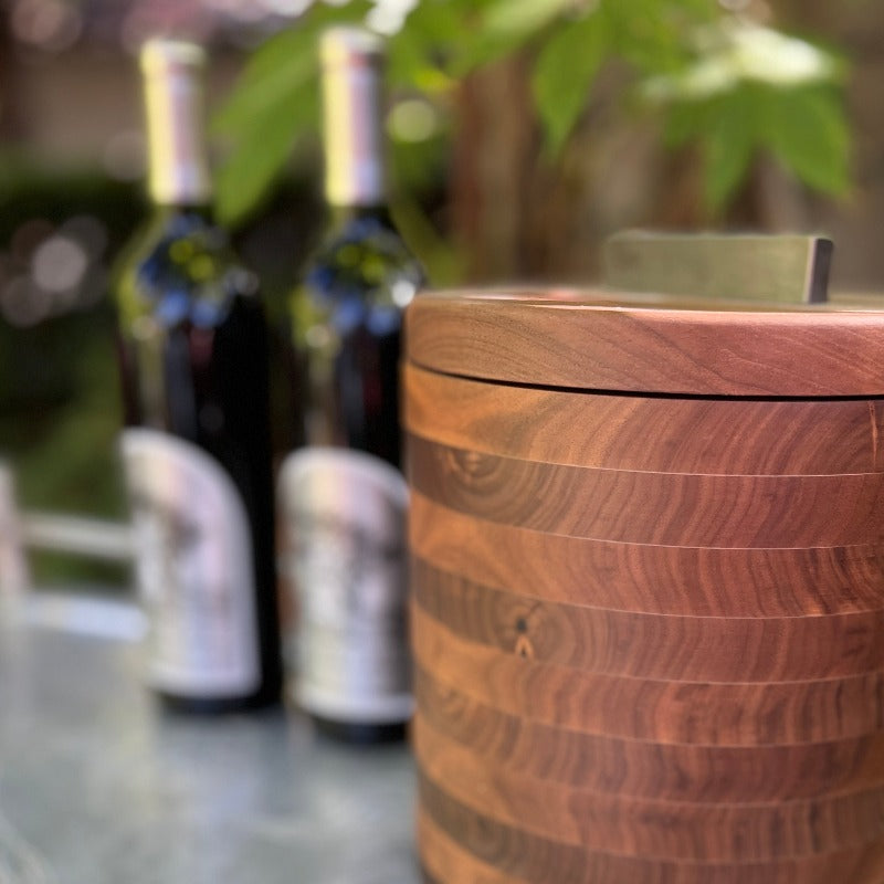 Modern Wooden Ice Bucket in Walnut pictured in front of bottles of wine