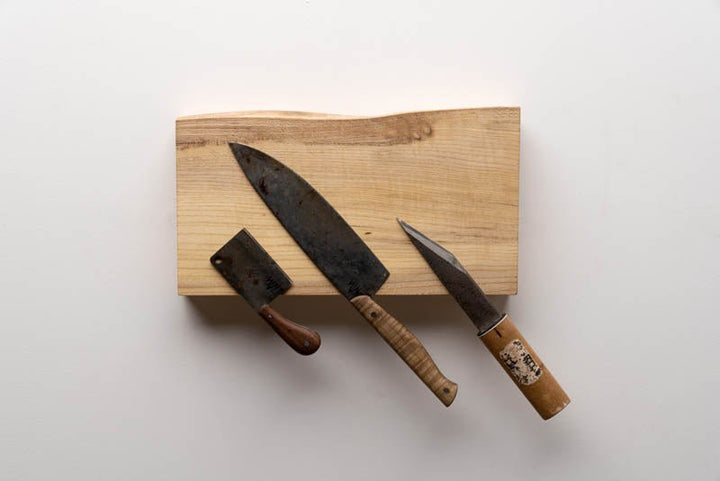 Magnetic Wooden Knife Holder holding kitchen knives