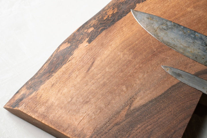 Magnetic Wooden Knife Holder holding kitchen knives zoomed in to show texture of wood