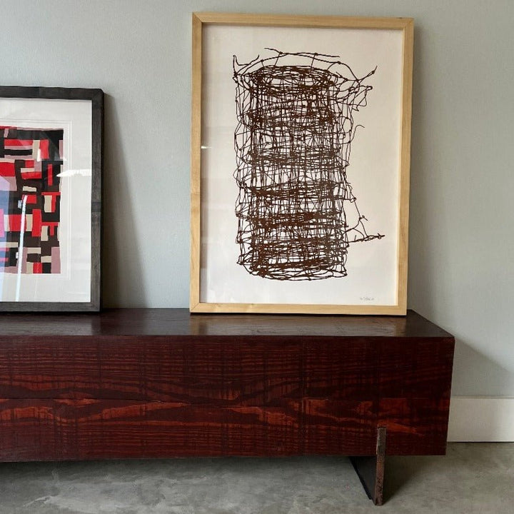 paintings sitting on mahogany bench