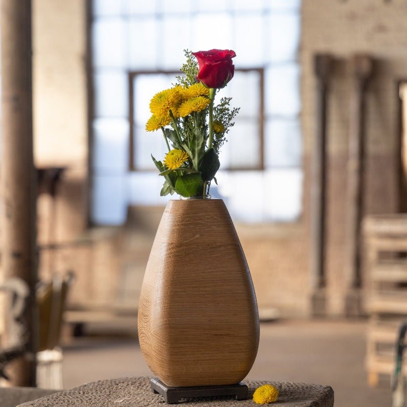 Wooden vase with flowers and a bronze base