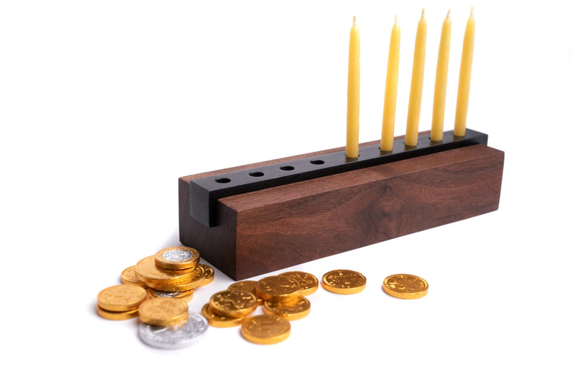 Modern Wood and Steel Menorah pictured with hanukkah candles and gold coins