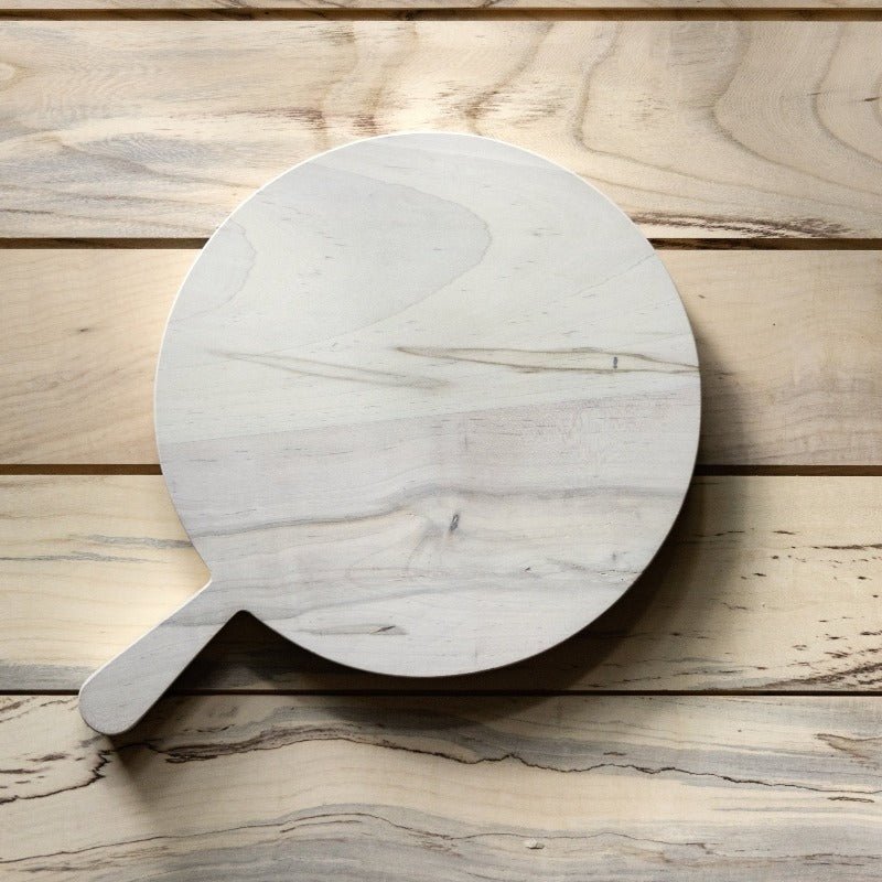 Maple Cutting Board with handle viewed from above on a wooden table